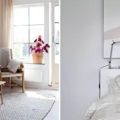 Mysigt litet sovrum med en säng med randigt påslakan och ett vardagsrum med soffa, fåtölj och ett lågt bord.