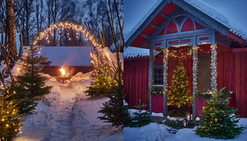 Vintermagi med julpynta utomhus. Snöklädda granar och gnistrande ljusslingor skapar en mysig julstämning vid en röd stuga och en eldfat.