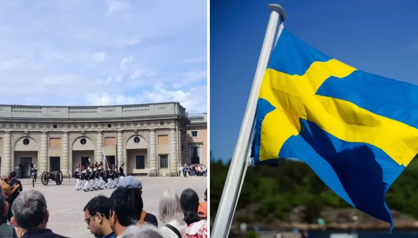 Vaktparad vid slottet i Stockholm på nationaldagen. Svenska flaggan vajar stolt i vinden.