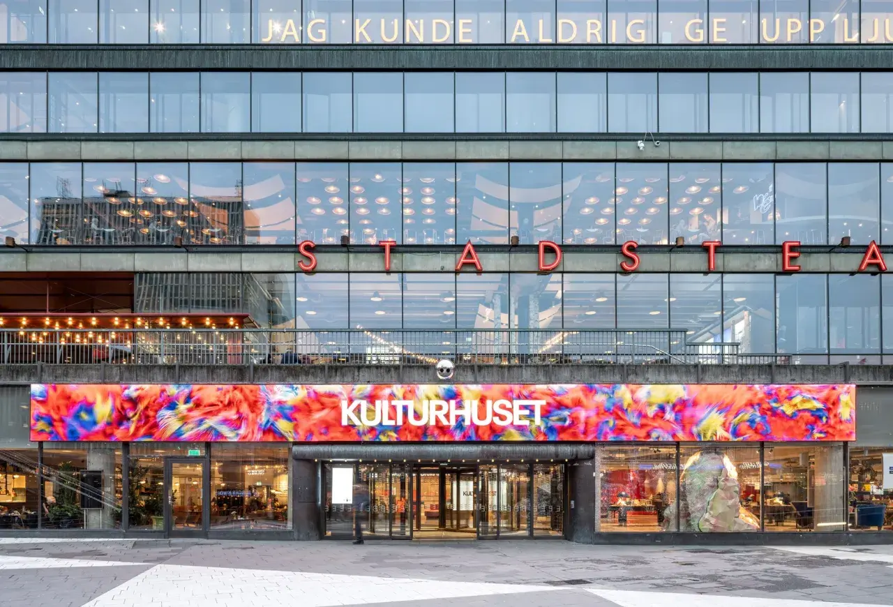 Stockholms kulturhus med en färgstark digital konstinstallation ovanför entrén.