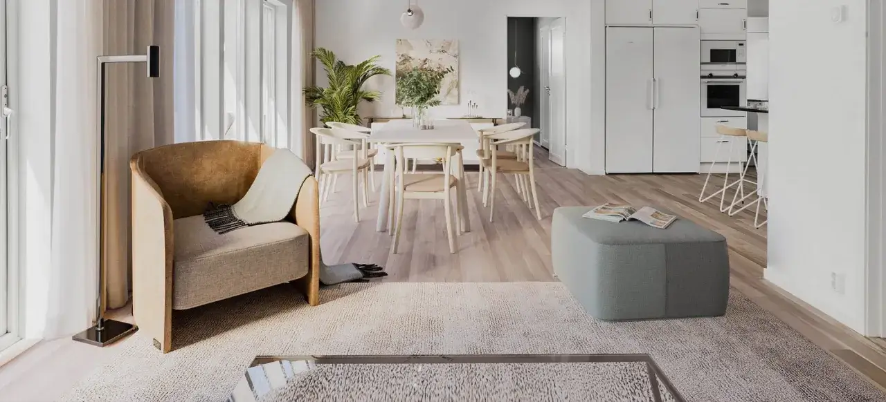 En ljus och luftig matplats och vardagsrum i nordisk design. En bekväm fåtölj, ett runt bord med stolar och en grön sittpuff.
